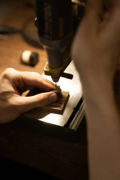 Workshop on wood and stone, machines for working with wood, manual work, the creation process. Hands work with a wood, close-up.