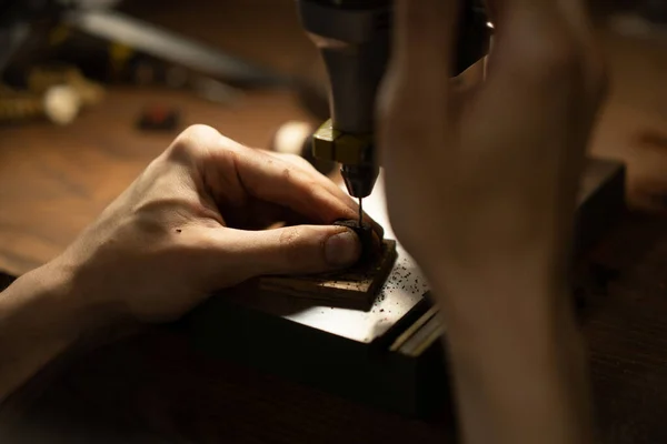 Workshop on wood and stone, machines for working with wood, manual work, the creation process. Hands work with a wood, close-up.