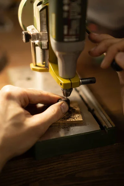 Workshop on wood and stone, machines for working with wood, manual work, the creation process. Hands work with a wood, close-up.