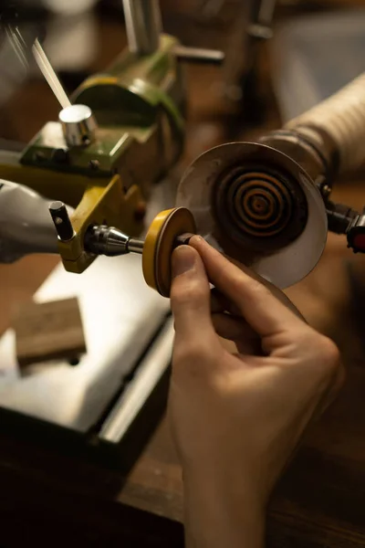 Workshop on wood and stone, machines for working with wood, manual work, the creation process. Hands work with a wood, close-up.