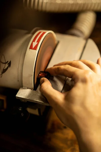 Workshop on wood and stone, machines for working with wood, manual work, the creation process. Hands work with a wood, close-up.