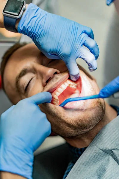 Handsome man smiling at dentist office