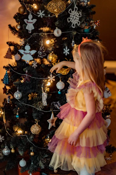 Uma Menina Decora Uma Árvore Natal Com Guirlandas Brinquedos Crianças — Fotografia de Stock