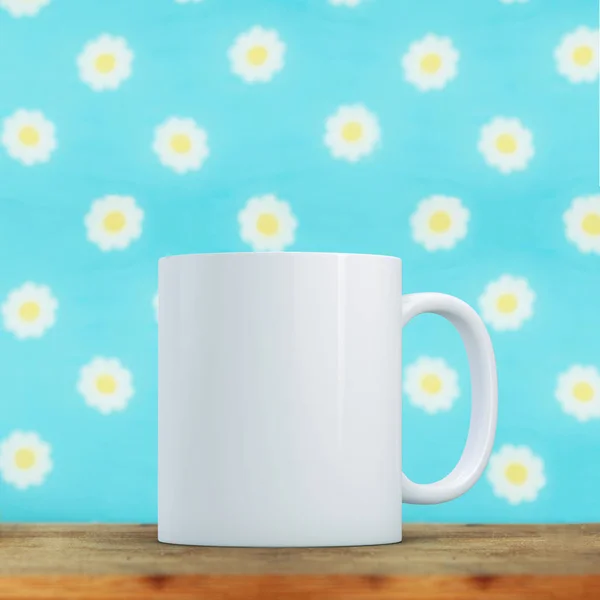 Blank white mug infant of a vibrant daisy background. Perfect for businesses selling mugs, just overlay your quote or design on to the image.