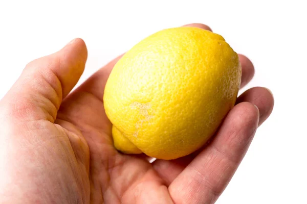 Mano causasiática sosteniendo un limón orgánico amarillo —  Fotos de Stock