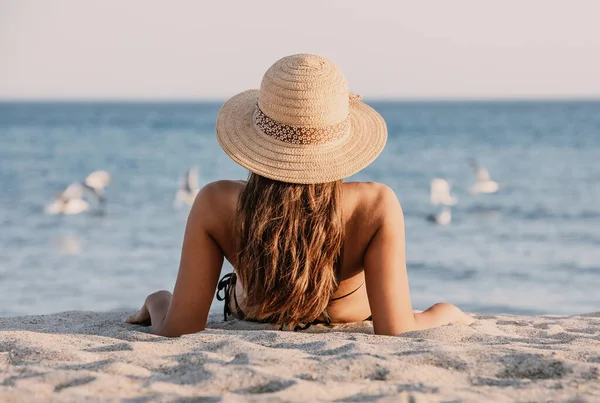 Young Girl Bathing Suit Hat Sitting Sand Beach Looking Seagulls — Stock Photo, Image