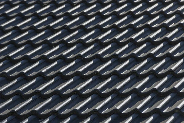 Roof hung with gray concrete roof tiles as background picture