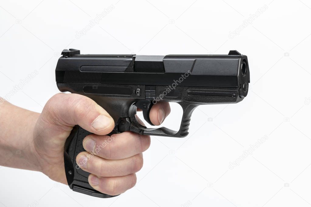 Hand of a male with firearm