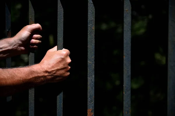 Two hand holding steel bars — Stock Photo, Image