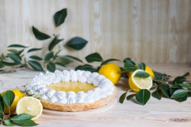 Açık ahşap zemin üzerine kremalı taze ev yapımı limonlu turta, seçici odaklanma, yatay yönelim