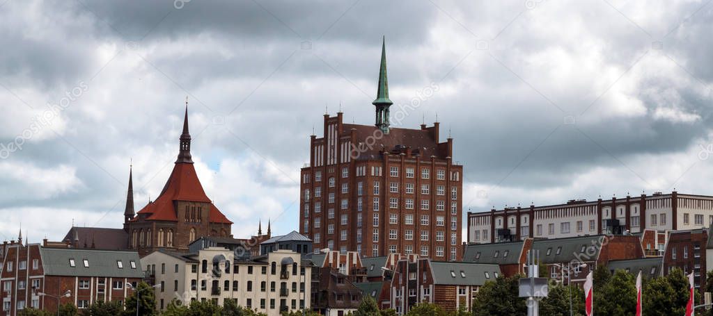 rostock old town with the st. maria curch and the carl zeiss skyscrapper under a cloudy sky, panoramic format with copy space