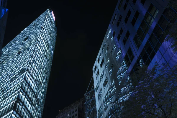 skyscraper buildings with illuminated windows in the night near the potsdamer platz in berlin germany, copy space