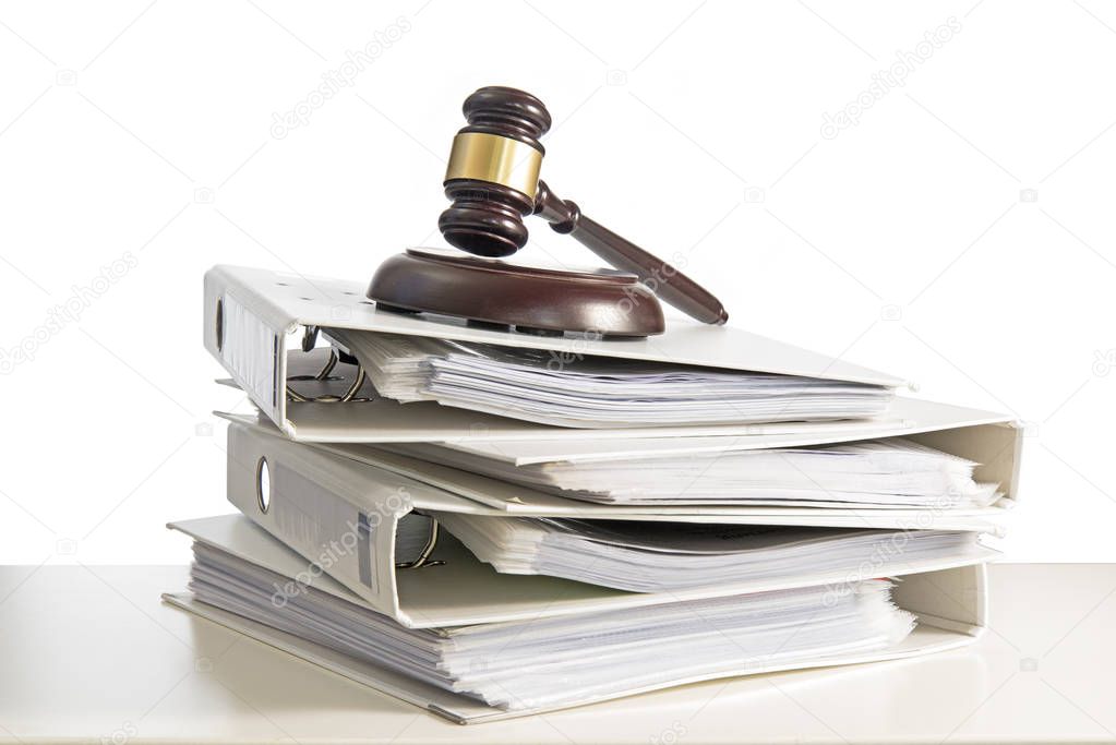 stack of folders and a judge gavel on a desk, isolated on a white background, concept for justice, business and finance, copy space, selected focus, narrow depth of field