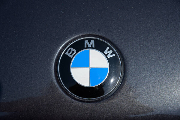RATZEBURG, GERMANY - JUNE 2, 2019: BMW, Bavarian Motor Works, logo emblem on a black metallic motor hood, classic automobile at the oldtimer car meeting in Ratzeburg, copy space