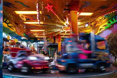 Noel lunapark pazarında çocuk araba Carousel, bulanık hareket ile uzun ssüresi pozlama