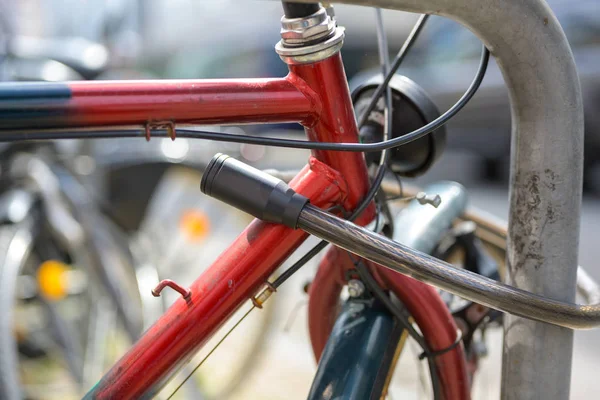 Detalle de bicicleta con cerradura encadenada a un marco, concepto de protección contra robo — Foto de Stock