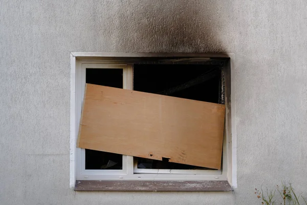Barricaded window after the fire damage in an apartment house, concept for arson, negligence and insurance — Stock Photo, Image