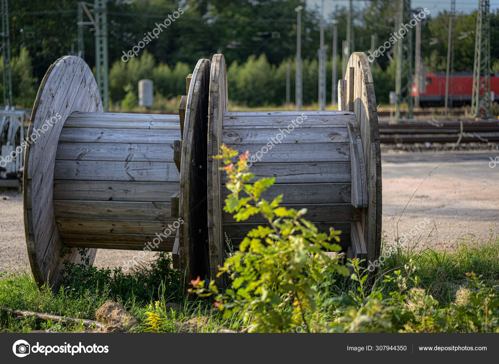 Large wooden cable reels on a construction site on the railway Stock Photo  by ©fermate 307944350