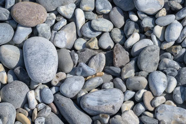 Seixos e pedras junto ao mar, composição de fundo abstrata — Fotografia de Stock