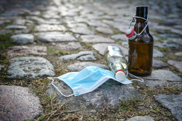 Beer Liquor Bottles Surgical Face Mask Left Cobblestone Road While — Stock Photo, Image