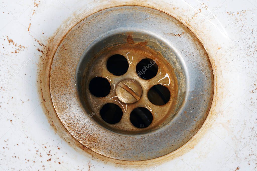 Rusty water in the sink. Hazardous tap water flows yellow.                               