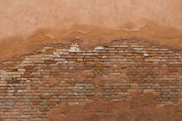 Old cracky brick wall with crumble paint and cement background in Italy, Venice