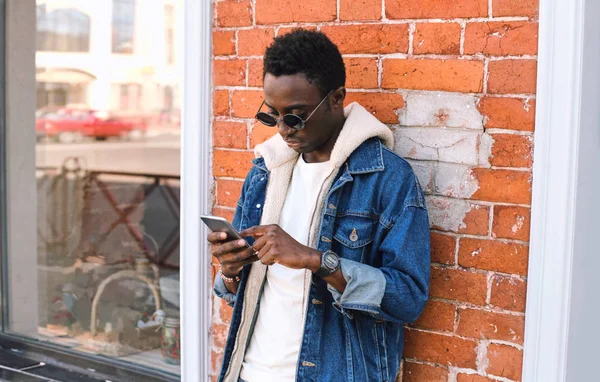 Portrait cool homme africain urbain avec téléphone sur la rue de la ville sur b — Photo