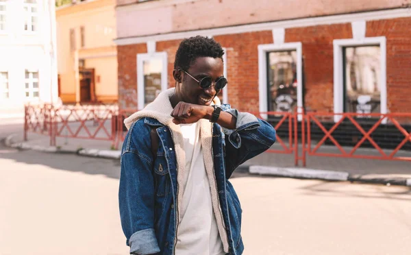 Fashion portrait smiling african man with smart watch using voic — Stock Photo, Image