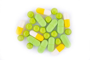 Pek çok renkli tıbbi hap beyaz bir arka planda izole edilmiş. Dikey çerçeve