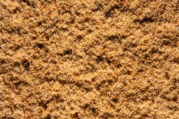 Hermoso fondo marrón claro arenoso hornear para el diseño. Primer plano de la superficie de arena —  Fotos de Stock