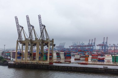 Almanya, Hamburg - 23 Haziran 2018: Konteyner terminal Almanya yükleme ve yük boşaltma için palamarla kargo gemileri ile Hamburg liman. Kötü hava durumu.