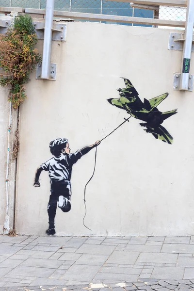 İsrail, Tel Aviv 'de savaş uçağı uçurtması olan Banksy sokak sanatçısı grafiti çocuğu. — Stok fotoğraf