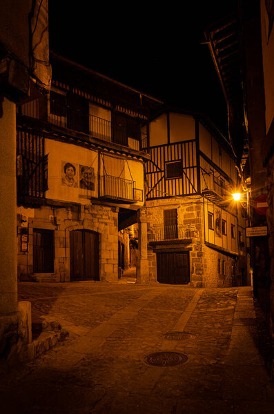 Streets of the village of Mogarraz illuminated at night, Salamanca, Spain