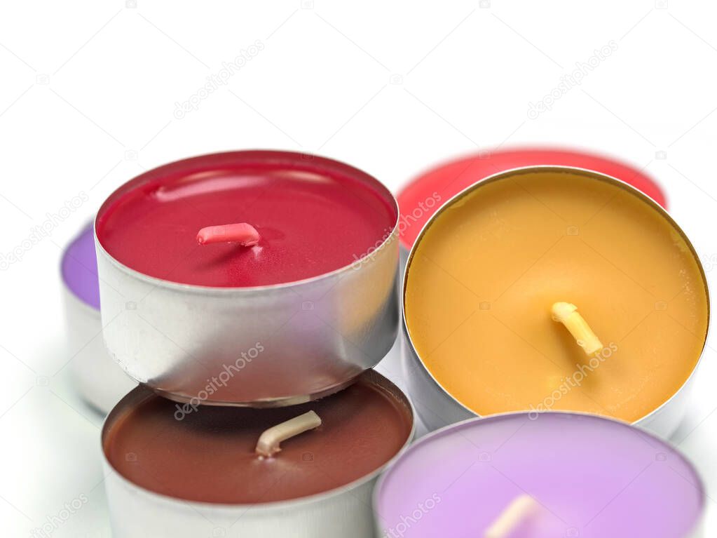 Colorful tea lights against white background