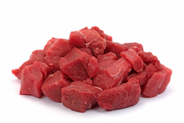 Goulash of beef, raw, against a white background