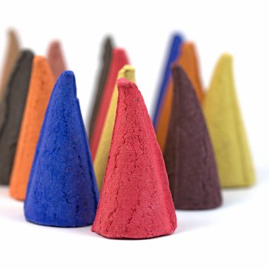 Renkli tütsü mumları, beyaz arka planda tütsü konileri.