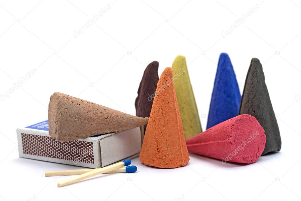 Colorful incense candles, incense cones in front of white background