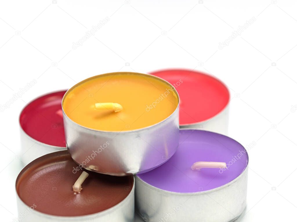 Colorful tea lights against white background