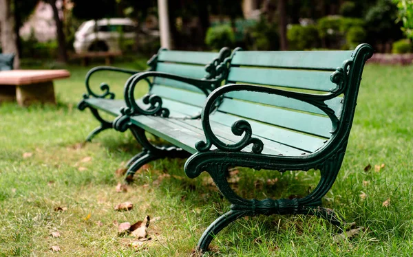 A green bench placed in a park to be relax