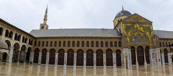 Damascus,Syria 03/28/2010: panorama of the  courtyard of the famous Umayyad Mosque a.k.a the Great mosque of Damascus.  Image shows minarets, marble floor, arches and pillars.