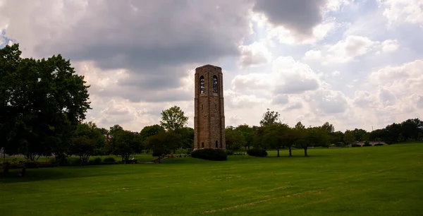 Image of Baker Park, Frederick on a cloudy day. Photo features the 70 foot granite tower housing a Carillon that is erected in memory of the local  philanthropist Joseph Dill Baker