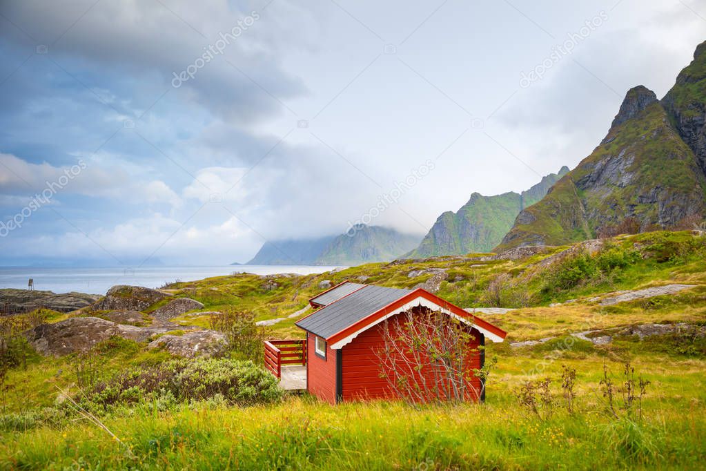 Traditional red camping houses with a beautiful sea view next to village A in lofoten, Norway