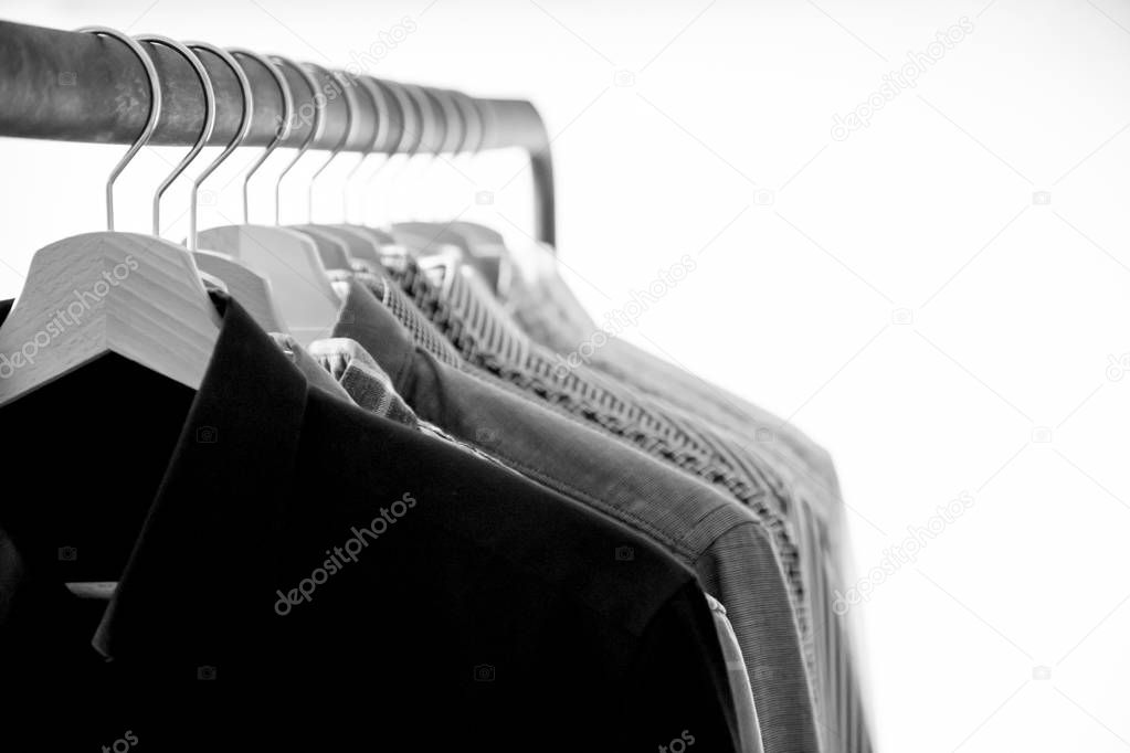 Row of mens shirts on hanger, black and white