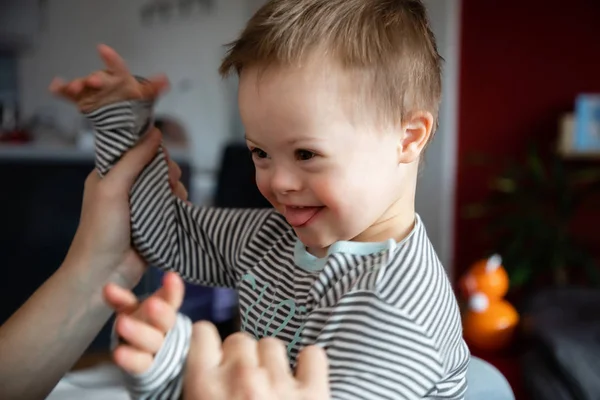 Cute boy with Down syndrome playing with dad on in home — Stock Photo, Image