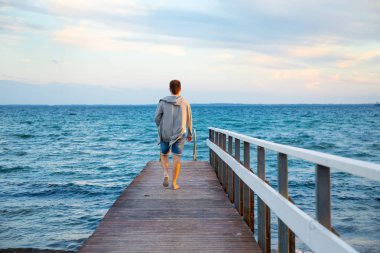 Genç adam günbatımı zamanı, Norveç on north sea beach
