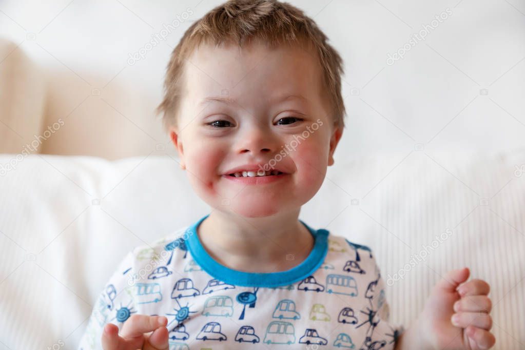 Portrait of cute small boy with Down syndrome