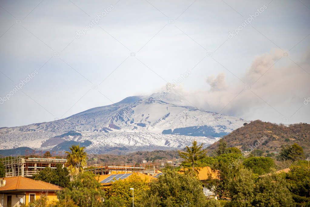 Etna Volcano with smoke in winter, volcano landscape from Catania, Sicily island, Italy