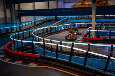 Prague, Czech Republic - September 21, 2025: Participants driving electric go-karts at CMKarting track. Sustainable motorsport, adrenaline entertainment and modern electric mobility. 