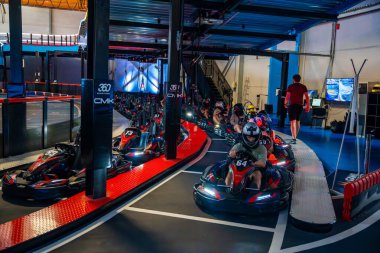 Prague, Czech Republic - September 21, 2025: Participants driving go-karts at CMKarting track. Recreational motorsport, adrenaline entertainment and modern leisure activities in an urban environment.