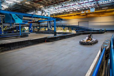 Prague, Czech Republic - September 21, 2025: Participants driving go-karts at CMKarting track. Recreational motorsport, adrenaline entertainment and modern leisure activities in an urban environment.